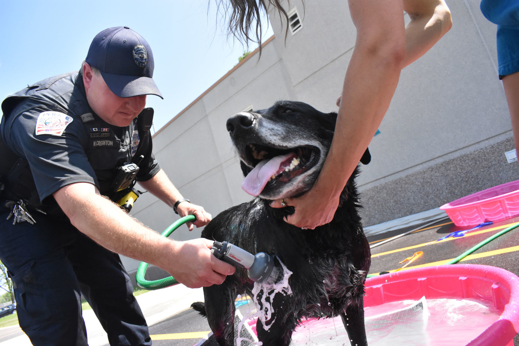 Officer Creighton washes a dog